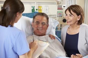 Nurse Talking To Couple On Ward