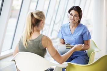 Nurse Meeting With Teenage Girl In Modern Hospital