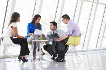 Businesspeople Having Meeting In Modern Office