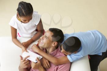 Overhead View Of Children Giving Father Gift