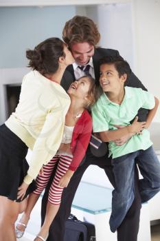 Family Greeting Father On Return From Work