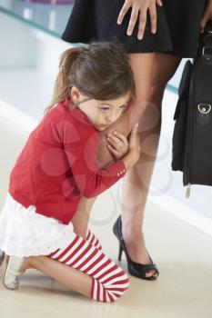 Daughter Clinging To Working Mother's Leg