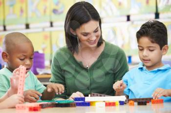 Elementary Pupils Counting With Teacher In Classroom