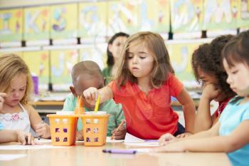 Group Of Elementary Age Children In Art Class With Teacher