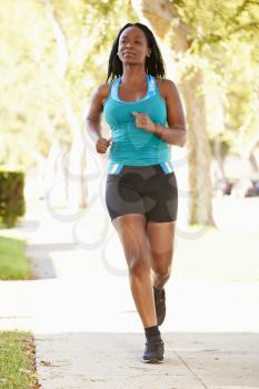 Female Runner Exercising On Suburban Street