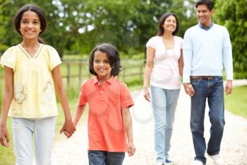 Indian Family Walking In Countryside