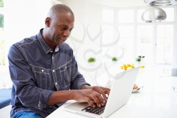 African American Man Using Laptop At Home