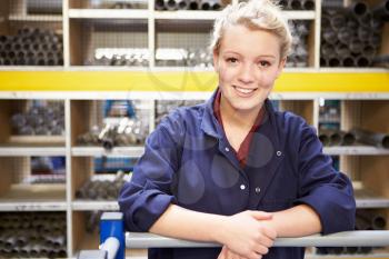 Portrait Of Female Engineering Apprentice In Store Room