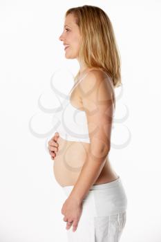 Studio Portrait Of 4 months Pregnant Woman Wearing White