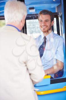 Senior Man Boarding Bus And Buying Ticket