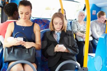Passengers Sitting On Bus Sending Text Messages