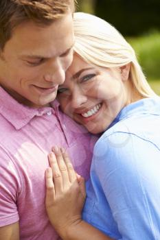 Romantic Young Couple Hugging In Garden