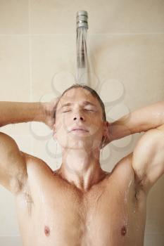 Man Taking A Shower In Bathroom