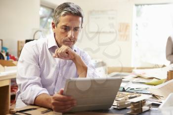 Architect Making Model In Office Using Digital Tablet