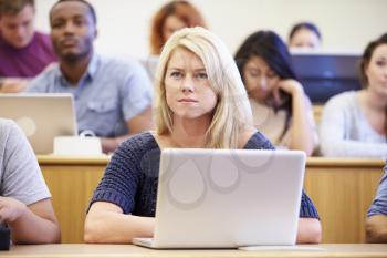 Female University Student Using Laptop In Lecture