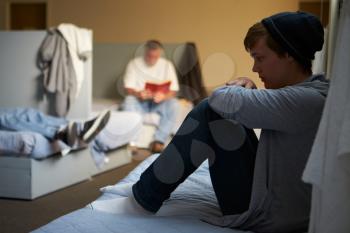 Men Lying On Beds In Homeless Shelter