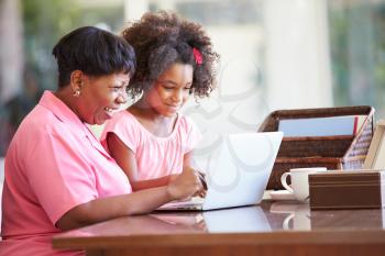 Granddaughter Helping Grandmother With Laptop