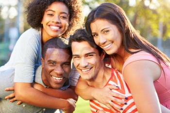 Outdoor Portrait Of Young Friends Having Fun In Park