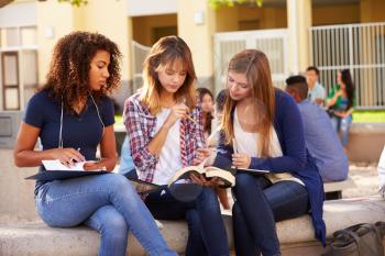 Three Female High School Students Working On Campus