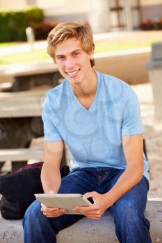 Male High School Student Using Digital Tablet Outdoors