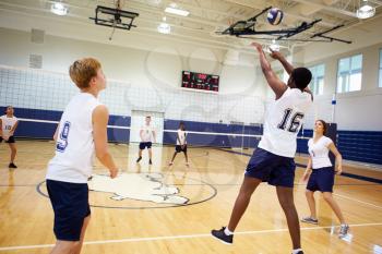 High School Volleyball Match In Gymnasium