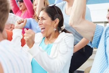 Woman In Crowd Celebrating At Sports Event