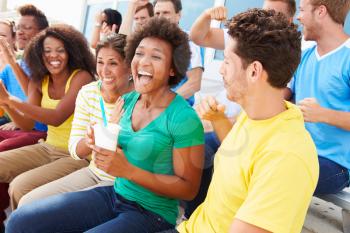 Spectators In Team Colors Watching Sports Event