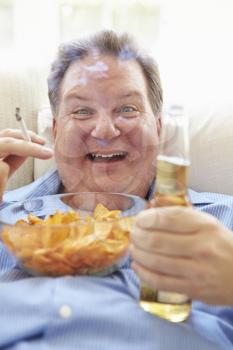 Overweight Man Eating Chips, Drinking Beer And Smoking