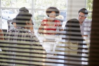 Designers Having Meeting Viewed Through Window