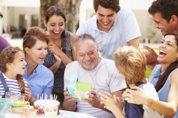 Multi Generation Family Celebrating Birthday In Garden