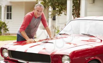 Retired Senior Man Cleaning Restored Classic Car