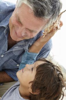 Young boy and grandfather with seashell