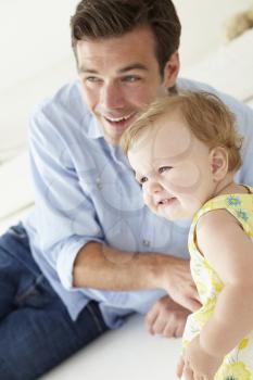 Father and baby daughter at home