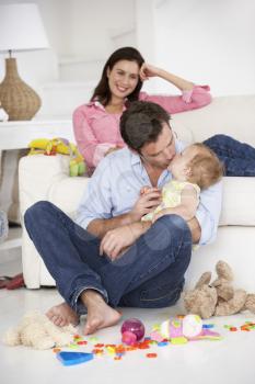 Parents at home with baby girl