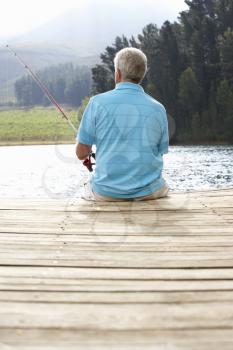 Senior man fishing on jetty