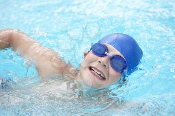 Boy swimming in outdoor pool