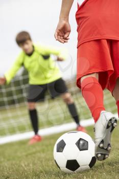 Boy goalkeeper braced for penalty shot