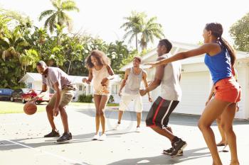 Group Of Young Friends Playing Basketball Match