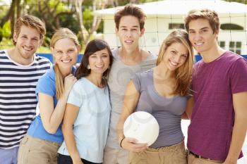 Group Of Young Friends Playing Volleyball Match