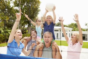 Multi Generation Family Playing Volleyball Together