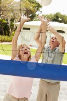 Senior Couple Playing Volleyball Match