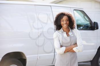 Woman Wearing Apron Standing In Front Of Van