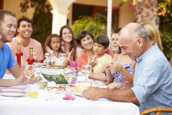 Large Family Group Celebrating Birthday On Terrace Together