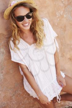 Portrait Of Pretty Young Woman Leaning Against Wall