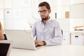 Businessman Using Laptop In Office Of Start Up Business