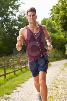 Man Running In Countryside Wearing Earphones