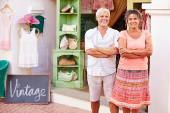 Mature Owners Of Fashion Store Standing Outside Shop