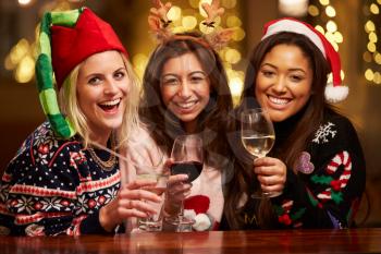 Group Of Female Friends Enjoying Christmas Drinks In Bar