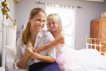 Daughter Hugging Mother As She Gets Dressed For Work