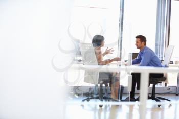 Two people talking in an office